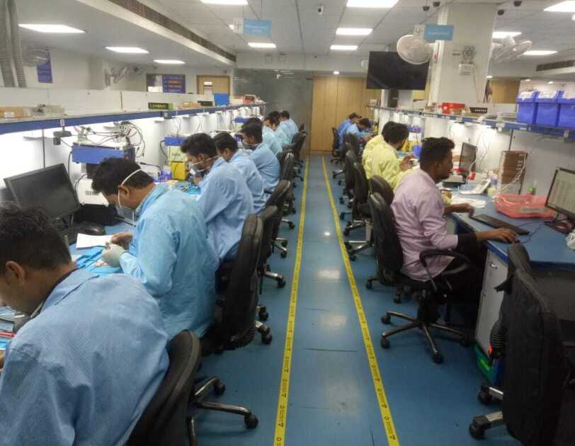 Technicians at work in the Yaantra lab working on refurbished phones